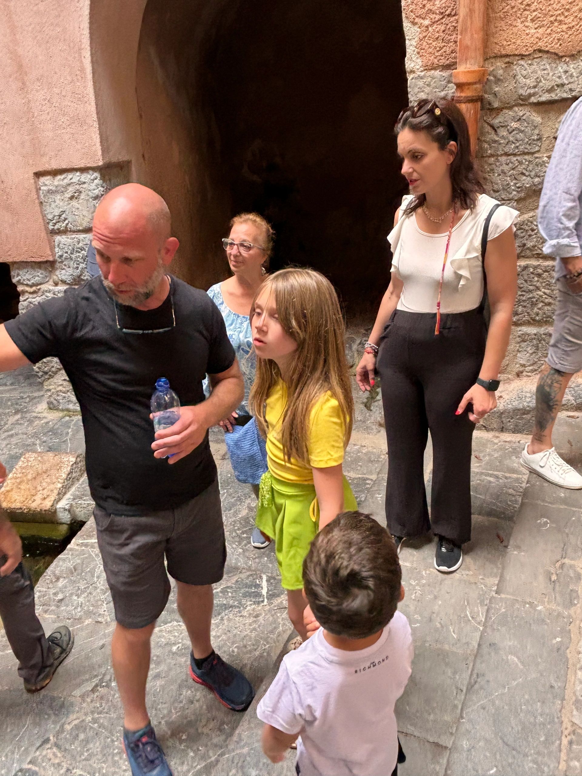 Family touring Italian cobblestone alley